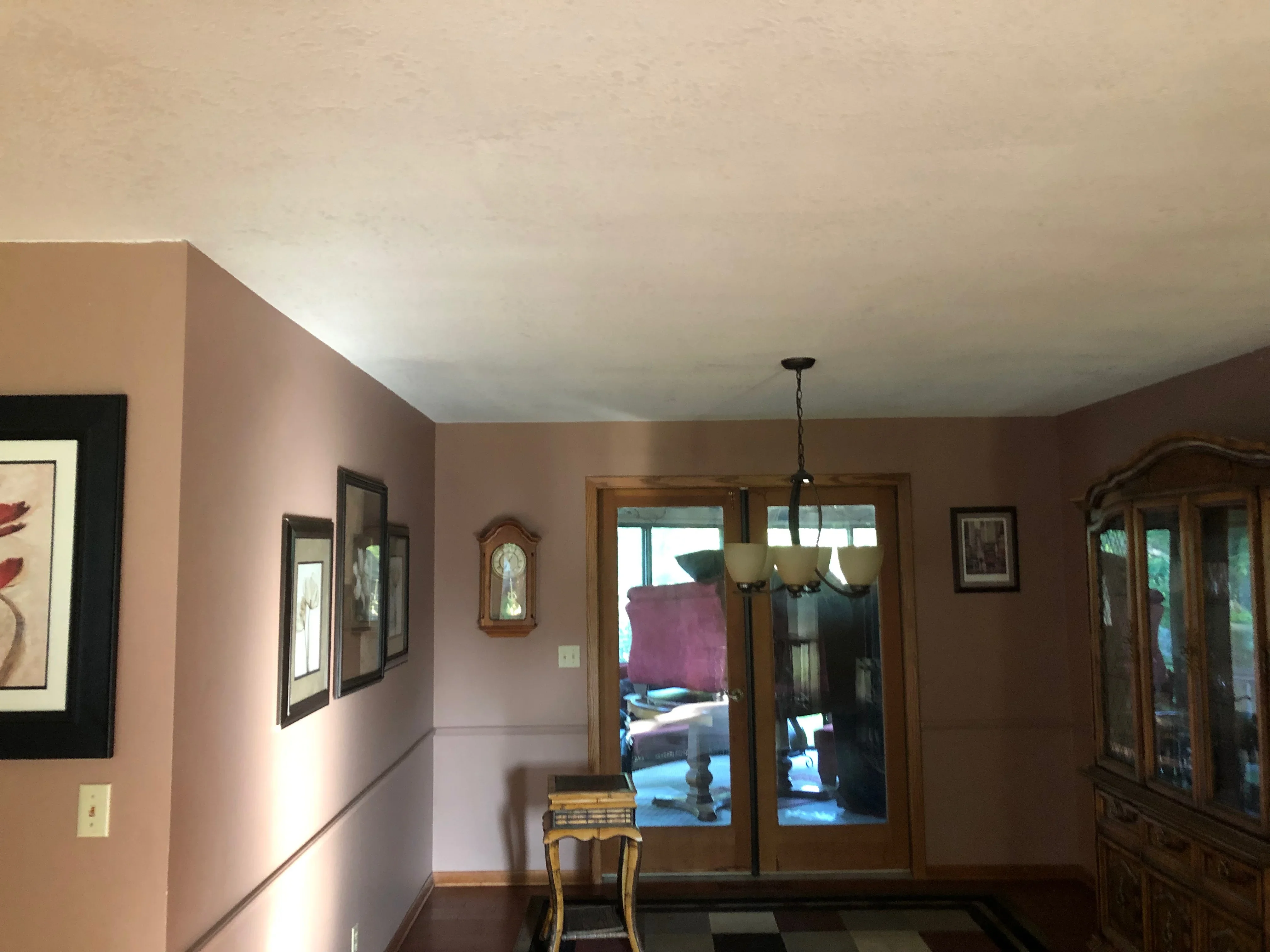 Mauve and taupe painted interior walls with white ceiling and wood trim in residential foyer