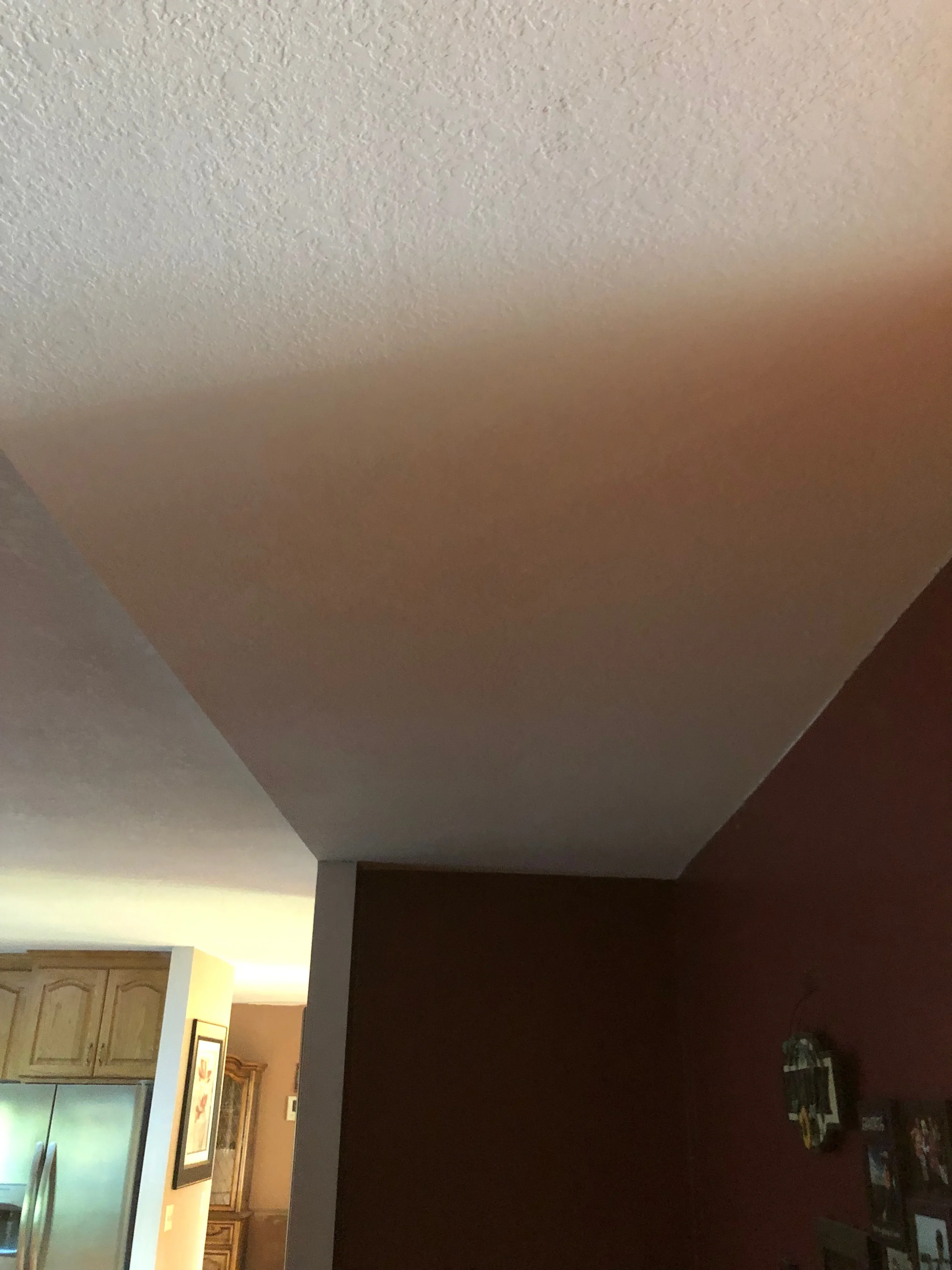 White textured ceiling and burgundy painted walls with clean trim lines