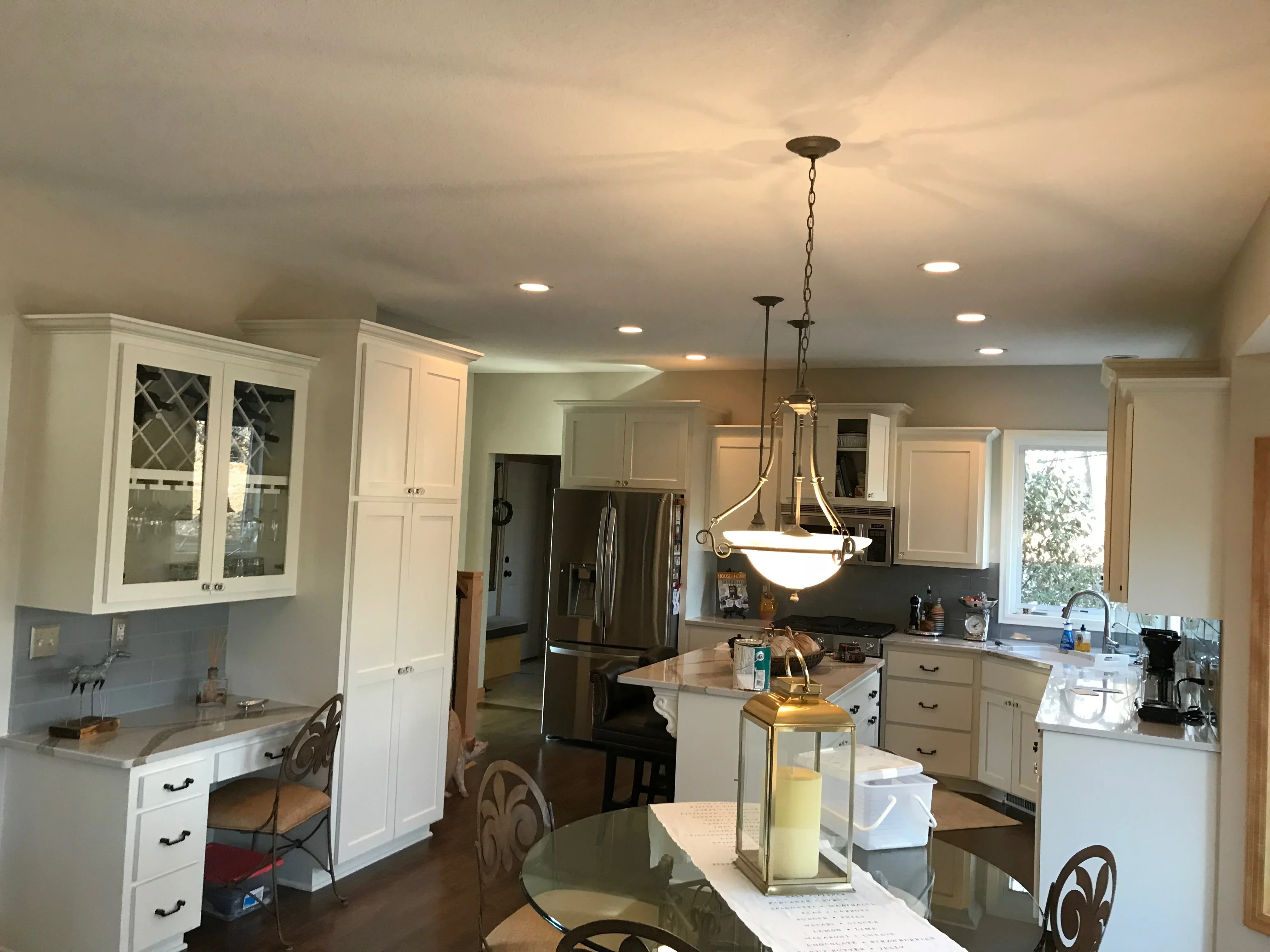 Painted kitchen ceiling with recessed lights, white cabinetry, and coordinated wall finishes
