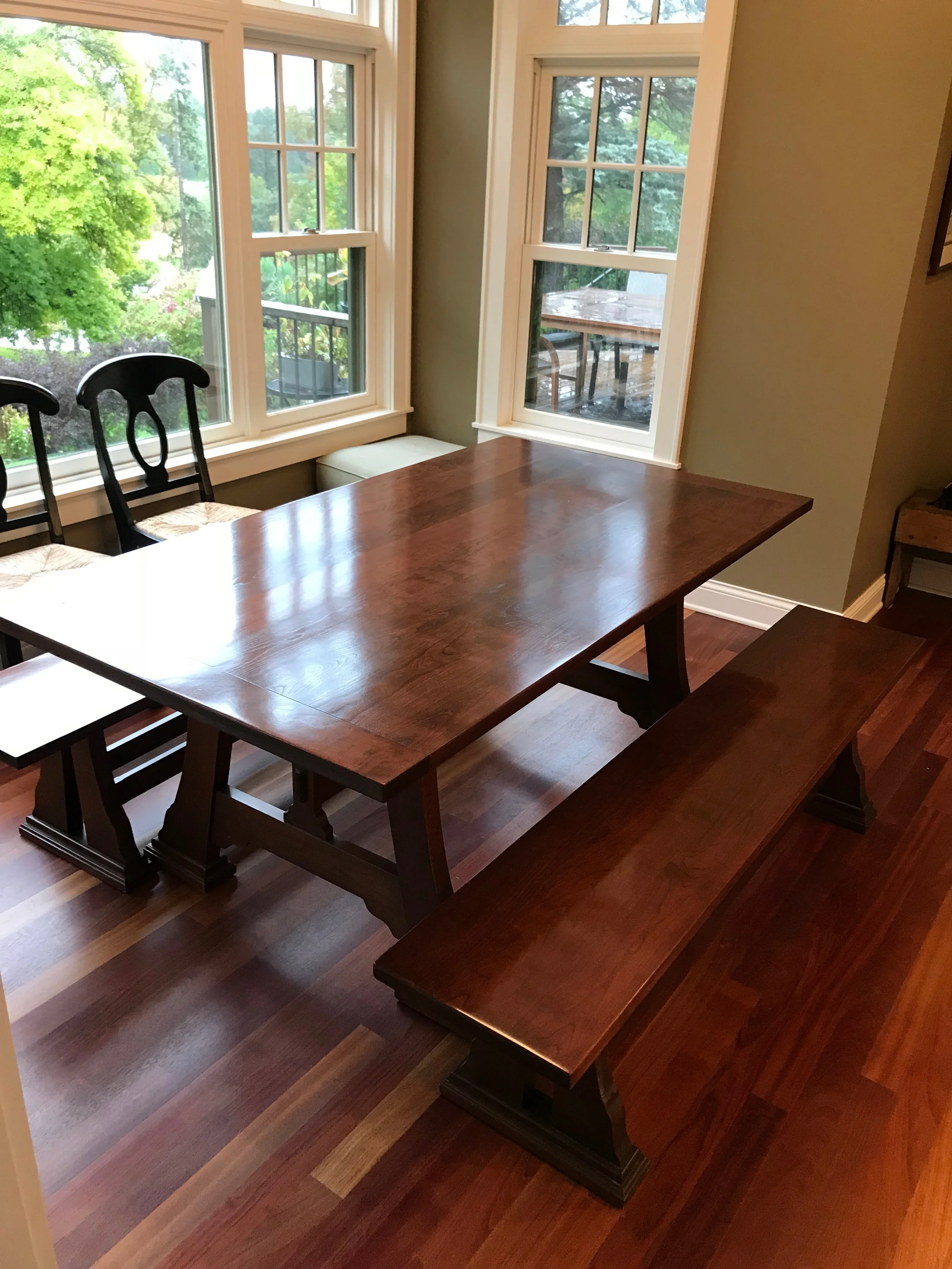 Painted dining room with neutral walls, white trim, and hardwood flooring