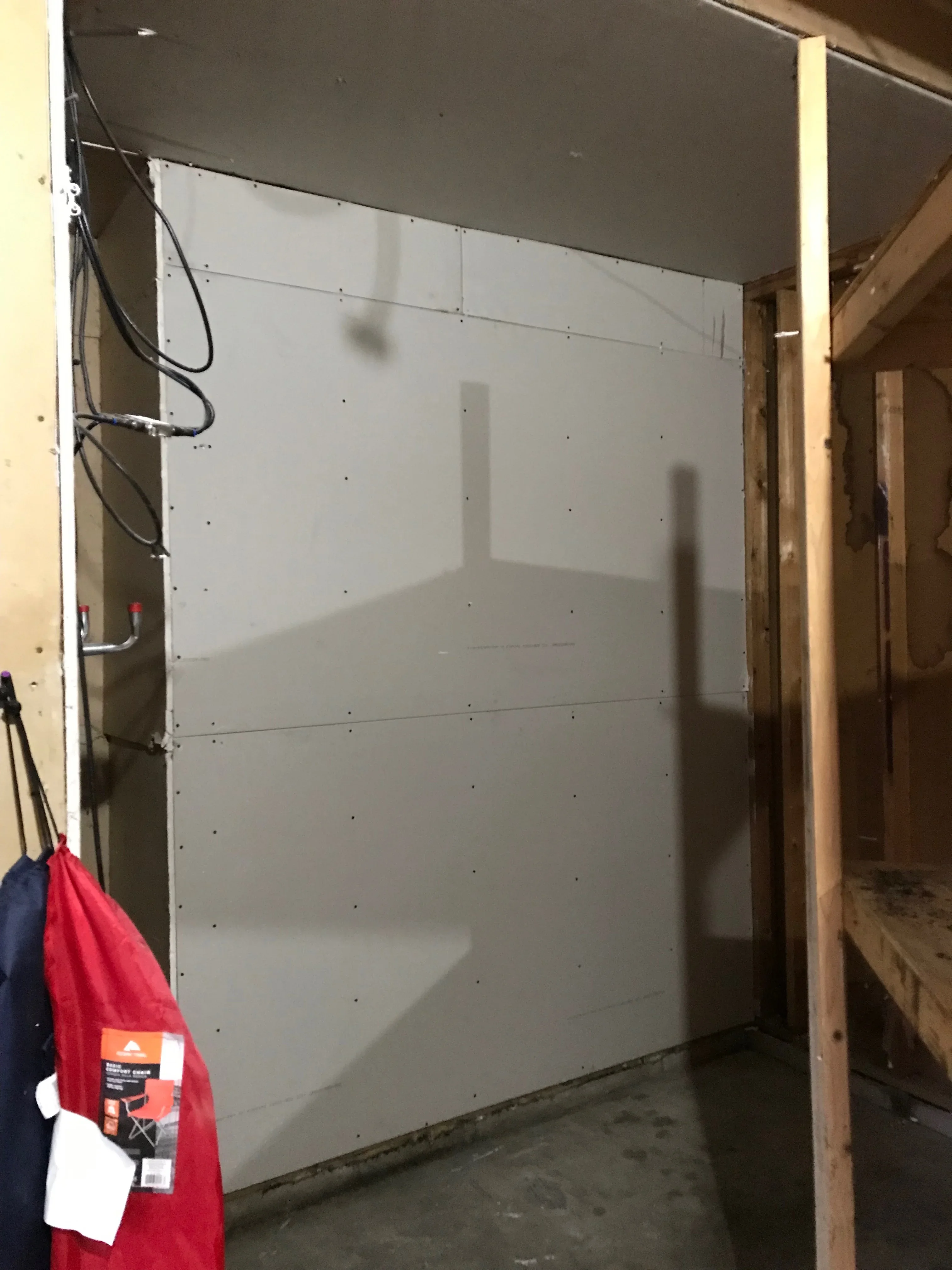 Drywall panels with taped seams and joint compound applied to interior wall