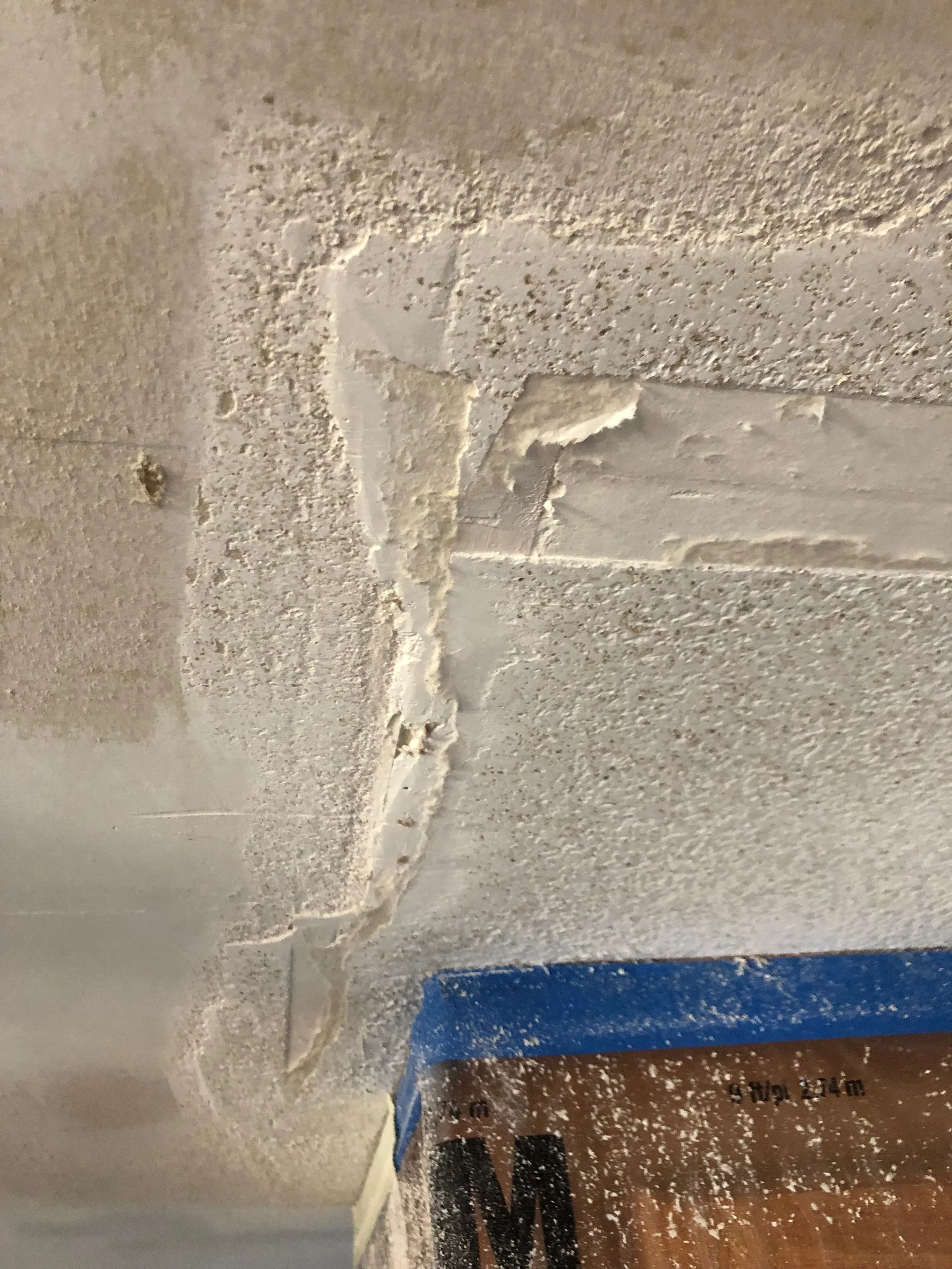 Drywall joint compound applied and sanded at interior corner seam